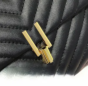 Close-up of black quilted leather bag featuring a polished gold twist-lock closure