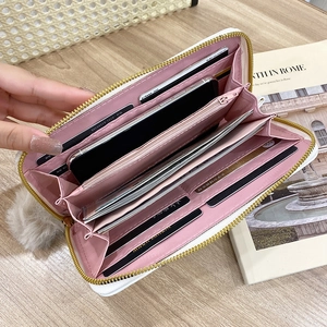 White zip-around wallet with pink lining featuring multiple card slots and phone pocket
