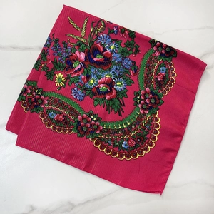 Macro detail of ethnic floral headscarf with gold metallic threads and colorful patterns