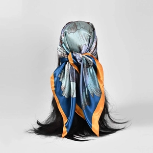 Floral satin silk scarf with vintage green and orange border tied on long dark hair