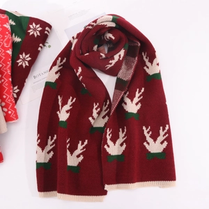 Close-up of red Christmas reindeer knitted scarf with warm ribbed edge detail