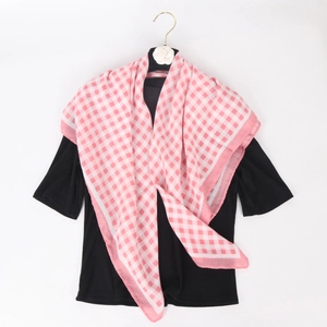 Pink and white checkered cotton linen scarf paired with black t-shirt on a hanger