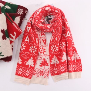 Detail of red and cream Christmas scarf with knit reindeer and snowflake patterns