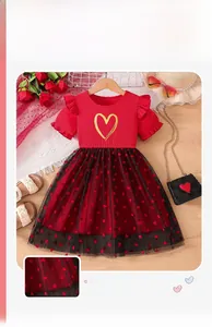 Detail of girls' red ribbed bodice dress with gold heart and black mesh tutu skirt