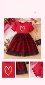 Detail of red girls' dress with heart-patterned black tulle skirt and ribbed bodice