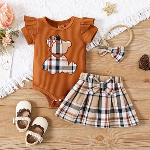 Tenue de bébé fille avec body marron, jupe à carreaux et bandeau assorti à plat