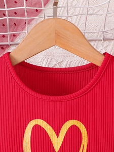 Girls' red ribbed dress with yellow heart print on a wooden hanger with mesh background