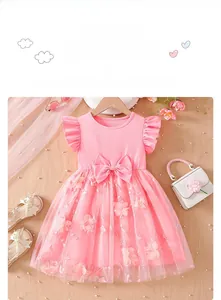 Close-up of pink girls dress featuring delicate floral embroidery and layered mesh skirt
