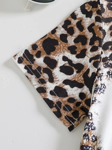 Detailed close-up of leopard print baby shirt sleeve with durable double-needle stitching