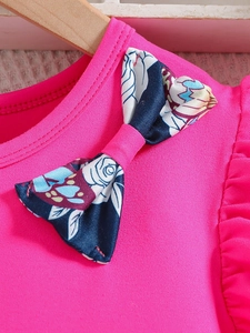 Girls summer rose red knit top featuring floral bow tie and ruffled sleeve details