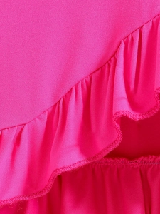 Detailed view of vibrant pink knit fabric featuring layered ruffles and precise overlock stitching