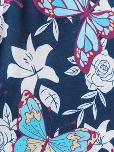 Detail of floral butterfly print on dark blue fabric for girls summer outfit set
