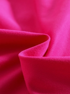 Detail of rose purple high-stretch knitted fabric with smooth texture and fine weave