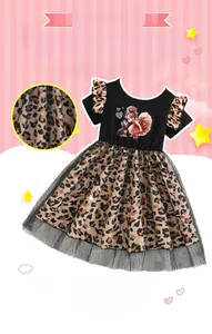 Detail of girl's summer dress with black cotton top and leopard print mesh skirt