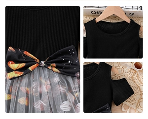Detail of cold-shoulder neckline and mesh flower print bow on girls' summer dress