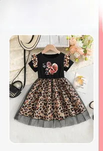 Detail of girl's dress featuring cartoon print, leopard pattern and black mesh layering