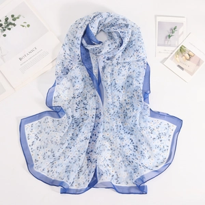 Close-up of lightweight floral georgette scarf with white flowers and blue borders