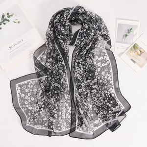 Detail of lightweight black and white floral chiffon scarf with fine white edge piping