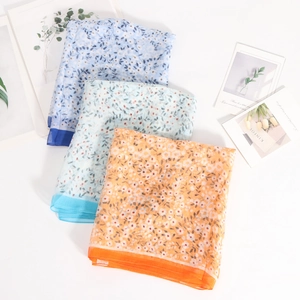 Floral georgette silk scarves in blue, mint, and orange colors on white background