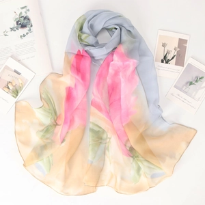 Macro detail of breathable rose print silk scarf with elegant gradient floral texture