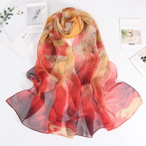 Pañuelo ligero de georgette con estampado floral solar en colores naranja y rojo