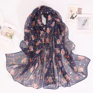 Detailed view of lightweight navy georgette scarf with vibrant small floral print