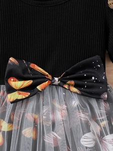 Girls black knit princess dress with butterfly bow and layered white tulle skirt