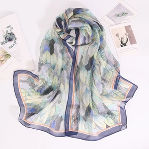 Macro detail of breathable feather-patterned chiffon scarf with soft gradient tones