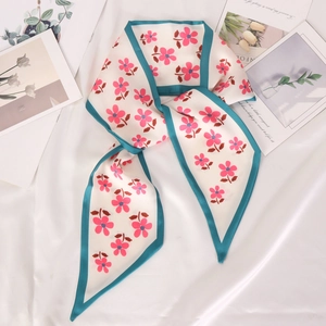 Narrow silk scarf with pink flower prints and teal edges on white background