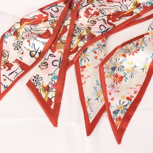 Narrow silk scarf featuring abstract face art and floral prints with red piping