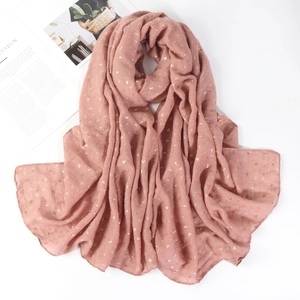 Detail of rose pink cotton linen scarf featuring gold foil flower patterns and crinkled texture