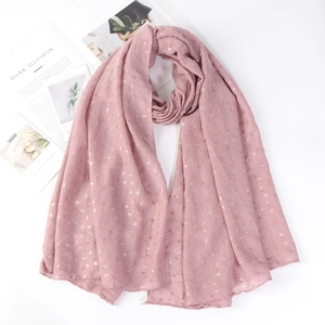 Detailed view of pink cotton linen scarf with elegant gold foil leaf patterns