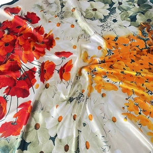 Orange jungle floral print silk scarf with satin glossy finish and artistic flower pattern
