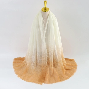 Women's gradient pashmina scarf transitioning from cream to orange with fringe edges