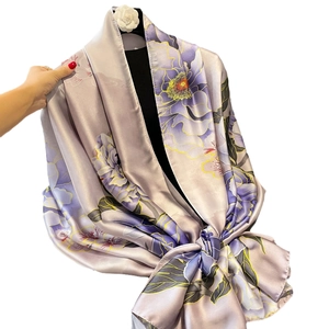 Elegant purple silk scarf with large floral print displayed on a black mannequin
