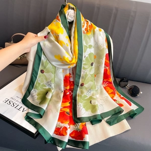 Elegant floral print satin silk scarf with bold green border and colorful flower patterns