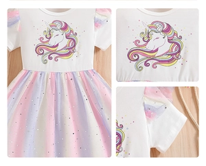 Detail view of cotton top with unicorn print and colorful sequined mesh rainbow skirt
