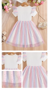 Detail view of rainbow tulle girl's dress with silver star and moon sequins