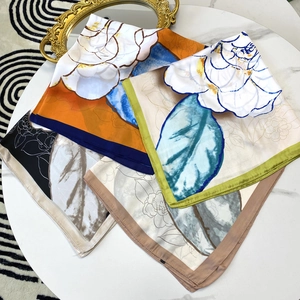 Elegant 70cm camellia floral silk scarves in multiple colors on white marble table