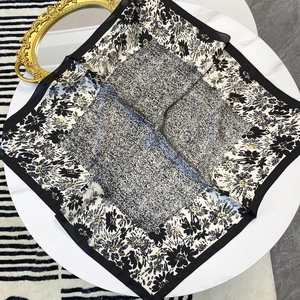 70cm floral silk scarf with black and white abstract patterns on a white table