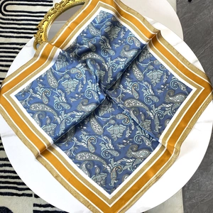 70cm Paisley-Seidenschal mit marineblauem und gelbem Rand auf weißem Marmorhintergrund