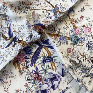 Detailed view of satin square scarf with floral and bird prints in traditional style