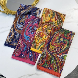 Vintage paisley satin silk scarf set in vibrant colors on white marble background