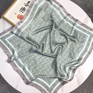 Elegant blue silk square scarf featuring vintage gold chain prints on a marble background