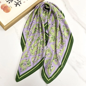 Elegant green and purple floral satin square scarf displayed on a marble background