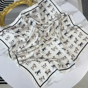 Elegant equestrian horse print square silk scarf with black border on marble surface