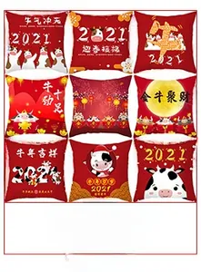 Detailed view of red festive pillowcases with Chinese New Year ox cartoons and gold text