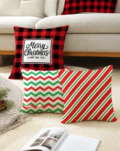 Detail of Christmas pillow covers featuring red plaid and deer patterns on a sofa