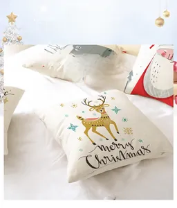 Detail of Christmas cushion covers with reindeer and Santa prints on soft fabric texture