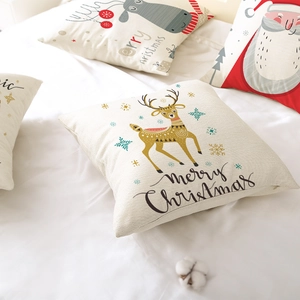 Festive Christmas pillow covers with Santa and reindeer prints on warm white fabric